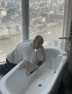 Working on resurfacing a bath